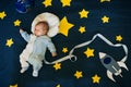 Sleeping baby boy astronaut on a background of the sky Royalty Free Stock Photo