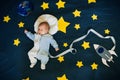 Sleeping baby boy astronaut on a background of the sky Royalty Free Stock Photo