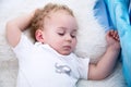 Sleeping baby boy. Close-up portrait of a beautiful sleeping baby boy in bed. Newborn, childhood theme Royalty Free Stock Photo