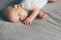 Sleeping baby boy in white bodysuit in bed with copyspace Royalty Free Stock Photo