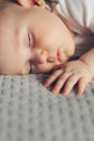 Sleeping baby boy in white bodysuit in bed with copyspace Royalty Free Stock Photo