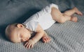 Sleeping baby boy in white bodysuit in bed Royalty Free Stock Photo