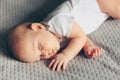 Sleeping baby boy in white bodysuit in bed Royalty Free Stock Photo