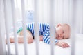 Sleeping baby boy in white crib