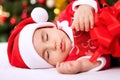 Sleeping baby child santa holding gifts Royalty Free Stock Photo