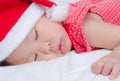 Sleeping baby girl Santa Claus Royalty Free Stock Photo