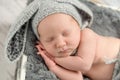 Sleeping baby in gray panties and hat with hare ears