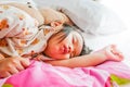 Sleeping baby or infant girl on bed in bedroom with teddy bear i