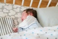 Sleeping baby. Peaceful baby lying on a bed while sleeping in a bright room Royalty Free Stock Photo