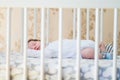 Sleeping baby. Peaceful baby lying on a bed while sleeping in a bright room Royalty Free Stock Photo