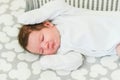 Sleeping baby. Peaceful baby lying on a bed while sleeping in a bright room Royalty Free Stock Photo