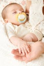 Sleeping baby portrait in mother hand, happy maternity and childhood concept, focus on face Royalty Free Stock Photo