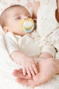 Sleeping baby portrait in mother hand, happy maternity and childhood concept, focus on hand Royalty Free Stock Photo