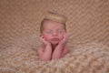 Sleeping baby propped on elbows Royalty Free Stock Photo