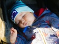 Sleeping baby in a stroller for a walk. close-up. Cute little boy sleeping outdoors Royalty Free Stock Photo