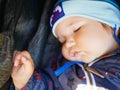 Sleeping baby in a stroller for a walk. close-up. Cute little boy sleeping outdoors Royalty Free Stock Photo