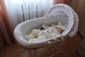 Sleeping beautiful 2 month old baby girl in a white knitted suit lies in her white crib Royalty Free Stock Photo