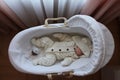 Sleeping beautiful 2 month old baby girl in a white knitted suit lies in her white crib Royalty Free Stock Photo