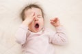 Sleeping beautiful and yawning baby toddler on the bed. Portrait