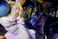 Sleeping beauty with evil witch looking at her. Colorful woman in blond hair with beautiful dress.Devil with big smile shows teeth