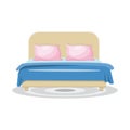 Sleeping bed with pink pillows and blue blanket, with grey rug. Royalty Free Stock Photo