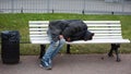 Sleeping on a bench homeless, Nevsky Prospekt, Saint Peterburg, Russia December 2020 Royalty Free Stock Photo