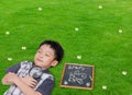 Sleeping boy with magnifying glass in grass field Royalty Free Stock Photo