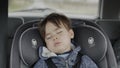 A sleeping boy of two years old rides in a car seat Royalty Free Stock Photo