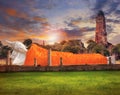 sleeping buddha statue and ancient brick pagoda against beautiful sun set sky with copy space use for beautiful asia scenic and r Royalty Free Stock Photo