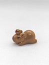 .Sleeping Capybara Figurine with Strawberry. Royalty Free Stock Photo