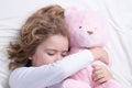 Daily sleeping. Child sleeping with a toy teddy bear in bed. Cute kid sleeping under blanket. Kid lying on pillow. Child Royalty Free Stock Photo