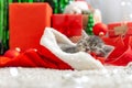Sleeping Christmas Cat. Beautiful little tabby sleeping kitten, kitty, cat in red Santa Claus hat on Christmas red gift box under Royalty Free Stock Photo