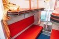 Sleeping compartment of a passenger train from the inside. Upper berth in the passenger interior of a sleeper compartment in a Royalty Free Stock Photo