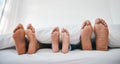 Sleeping, feet and family in a bed with love, relax and resting in comfort in their home together. Barefoot, care and Royalty Free Stock Photo