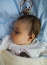 Sleeping girl in bed with teddy bear Royalty Free Stock Photo