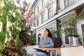 Sleeping girl with laptop is yawning outdoor on terrace in cafe. Tired young woman have a break at work and sleeping and Royalty Free Stock Photo