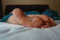 Sleeping girl, feet on the bed