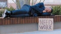 Sleeping homeless fired African American man in city tired with searching job relax on bench. Male sleep outdoors with