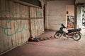 Sleeping Indonesian man and motorbike, Medan, Indonesia