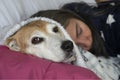 Sleeping lady rests together with her dog under the covers Royalty Free Stock Photo