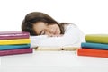 Sleeping while learning - tired little girl sleeping on desk.