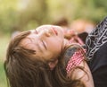 Sleeping little girl on mother shoulder in nature park. Royalty Free Stock Photo