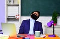 Sleeping male student in classroom. Tired overworked teacher sleep at desk. Knowledge and educational school concept Royalty Free Stock Photo