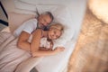Mature couple sleeping on a bed together