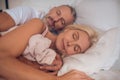 Mature couple sleeping on a bed together