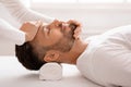 Sleeping man getting healing face massage at spa Royalty Free Stock Photo