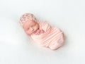 Sleeping newboen baby in a pink wrap Royalty Free Stock Photo