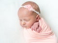 Sleeping newboen baby in a pink wrap Royalty Free Stock Photo