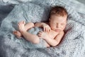 Sleeping newborn baby boy swaddled in a nest Royalty Free Stock Photo