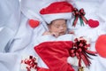 Sleeping newborn baby face in Christmas hat with gift box from S Royalty Free Stock Photo